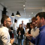 A gathering of business people at an event standing talking