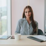 Business woman sitting at a desk in her office